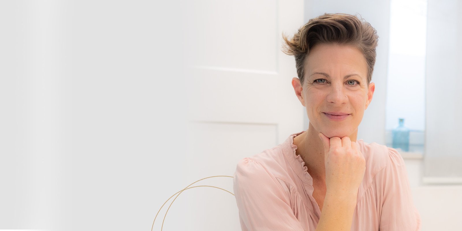 Manuela Heining sitzt lächelnd in ihrer Praxis für Dentosophie in Grafenwöhr